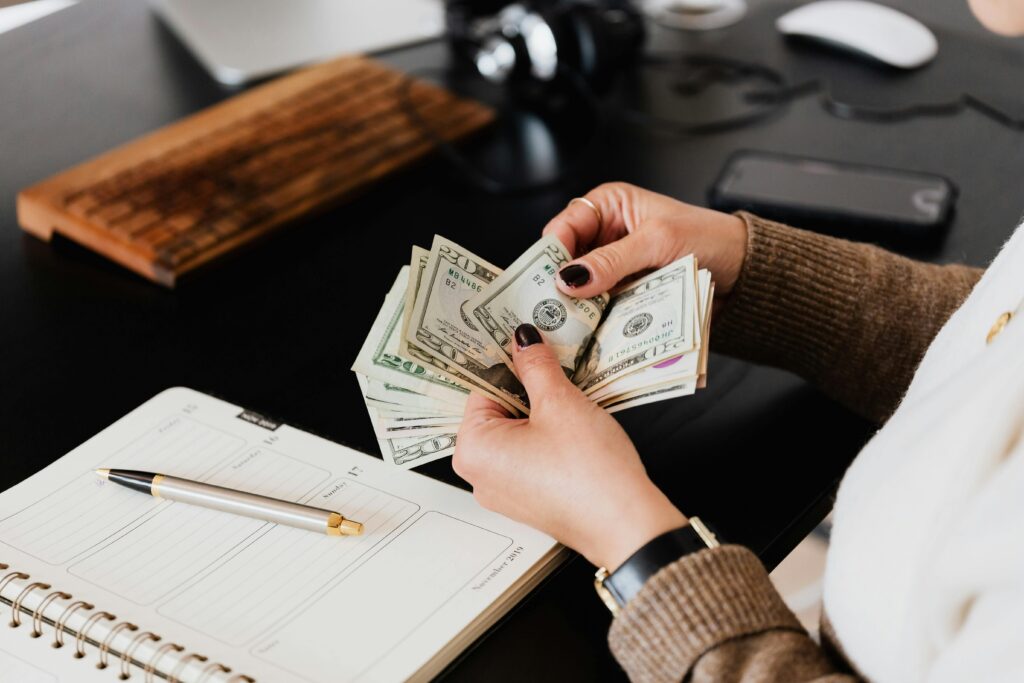 Passive Income with AI - Money Earned While Sleeping Person counting cash after earning passive income with AI tools