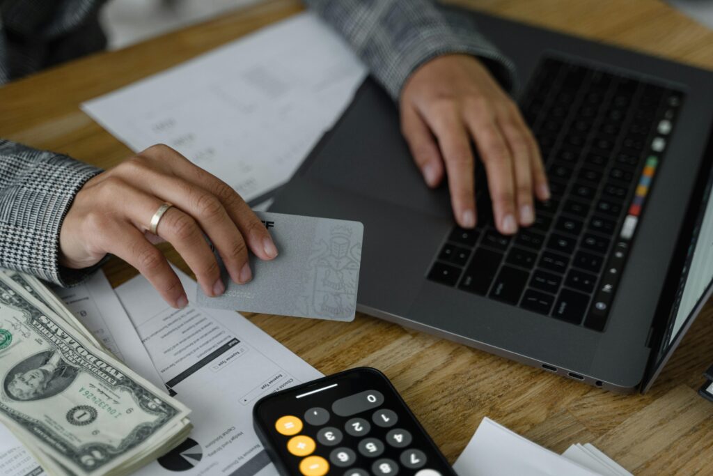 How to Earn Money Online – Real Setup With Laptop and Card Person using laptop and holding credit card demonstrating how to earn money online